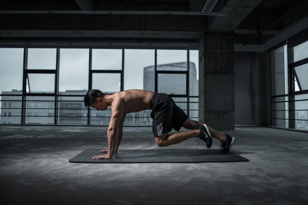 Athletic man performing mountain climbers in an industrial-style gym – full-body workout for strength and cardio necessary for lose weight